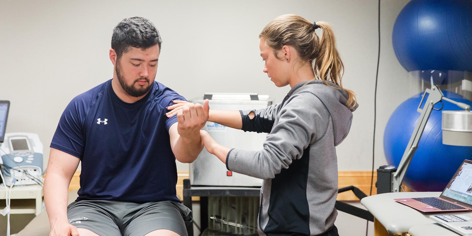 Male And Female Student Training To Be Atthletic Trainers